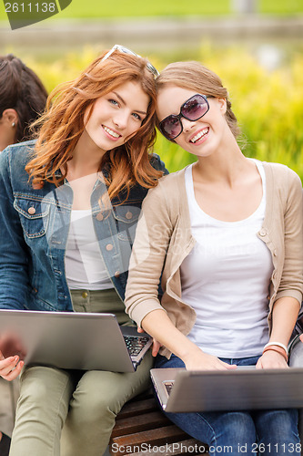 Image of two female students with laptop computers