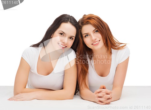 Image of two laughing girls in white t-shirts