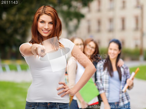 Image of teenager in blank white t-shirt pointing at you