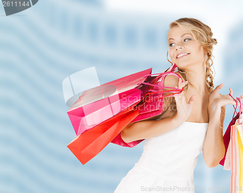Image of woman with shopping bags in dress