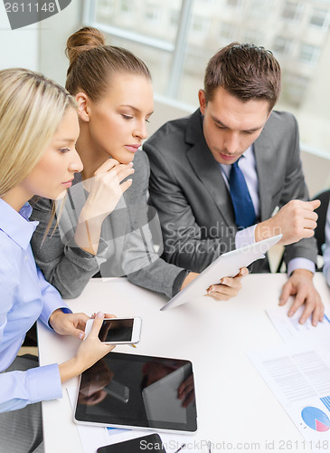 Image of business team with tablet pc having discussion