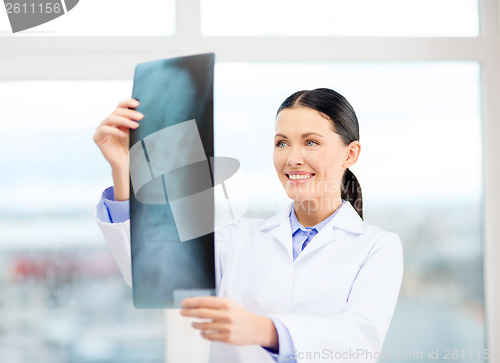 Image of smiling young doctor in cabinet