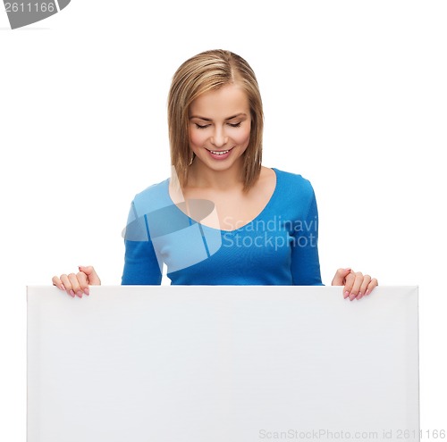 Image of smiling girl lkooking at blank white board