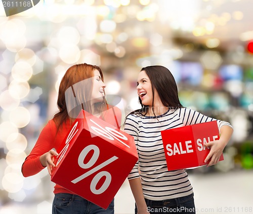 Image of smiling teenage girl with percent and sale sign