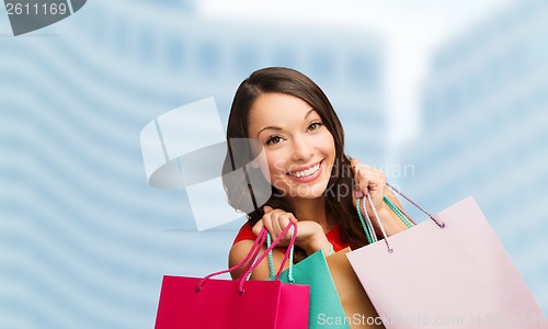 Image of woman in red dress with shopping bags