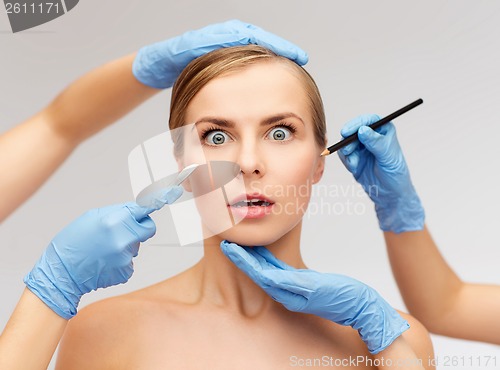 Image of woman face and beautician hands with pencil