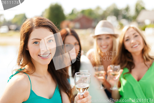 Image of smiling girls with champagne glasses