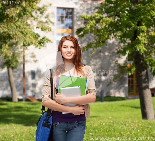 Image of smiling student with bag, folders and tablet pc