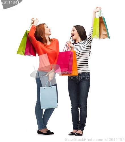 Image of two smiling teenage girls with shopping bags