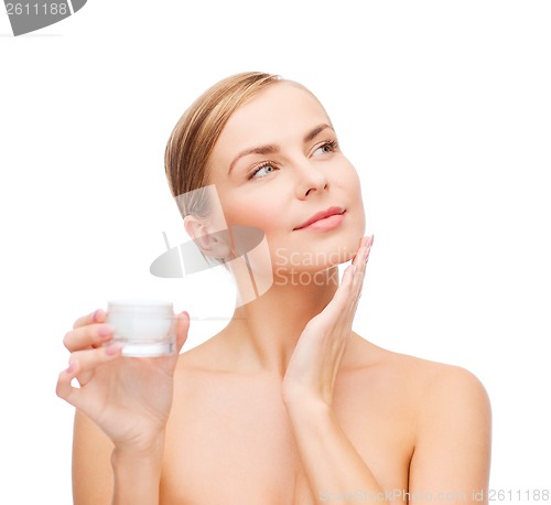 Image of woman applying cream on her skin