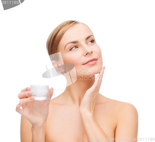 Image of woman applying cream on her skin