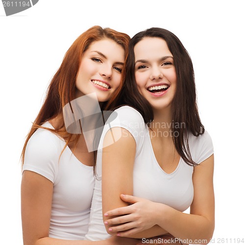 Image of two laughing girls in white t-shirts hugging