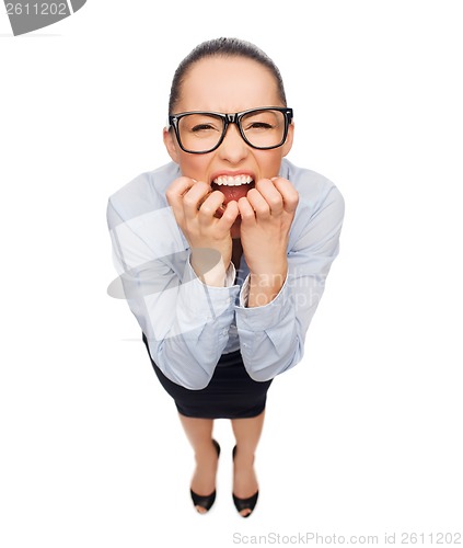 Image of frightened businesswoman biting her fingers