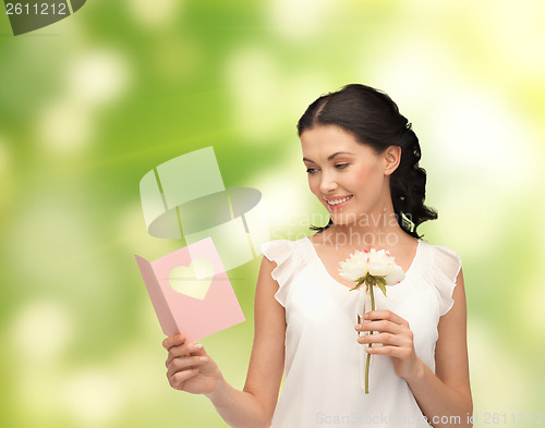 Image of young woman holding flower and postcard