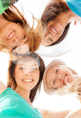 Image of faces of girls looking down and smiling