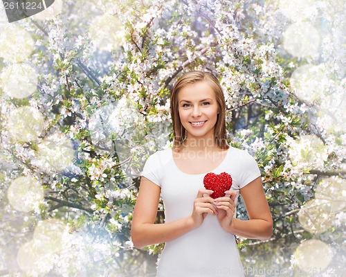 Image of smiling woman in white t-shirt with heart