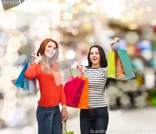 Image of two smiling teenage girls with shopping bags