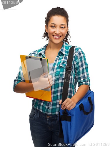 Image of smiling student with folders, tablet pc and bag