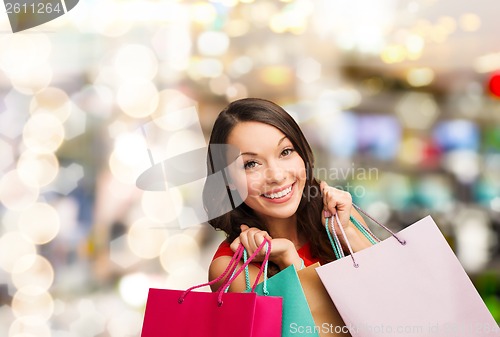 Image of woman in red dress with shopping bags