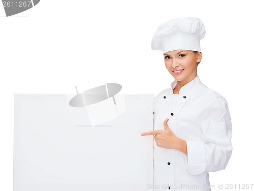 Image of smiling female chef with white blank board