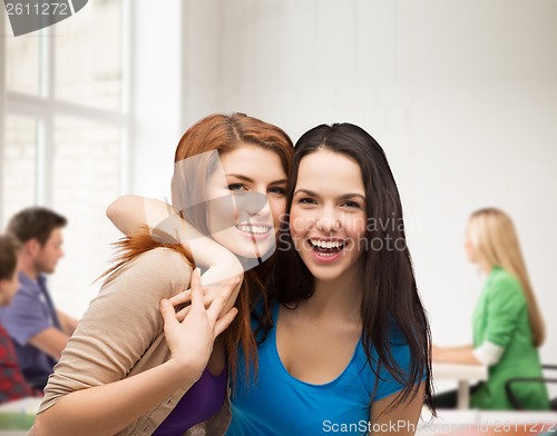 Image of two laughing girls hugging