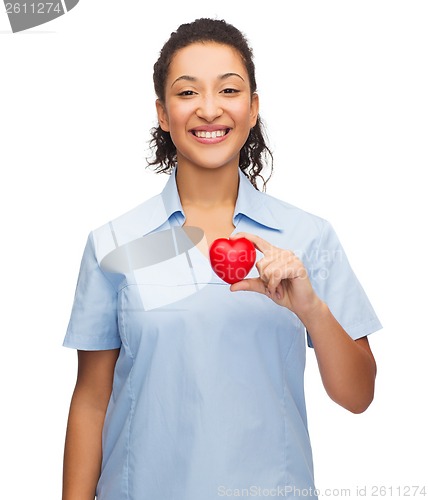 Image of smiling female doctor or nurse with heart