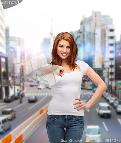 Image of teenager in white t-shirt pointing at you