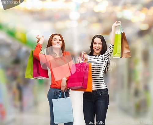 Image of two smiling teenage girls with shopping bags