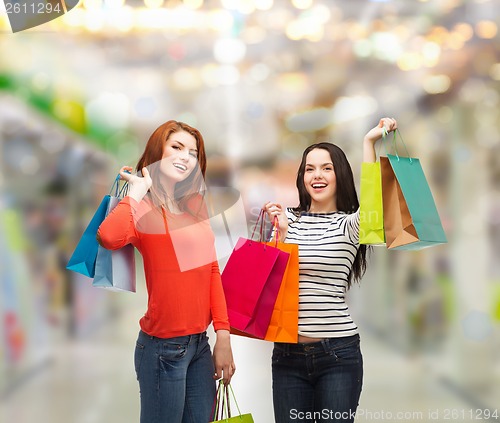 Image of two smiling teenage girls with shopping bags