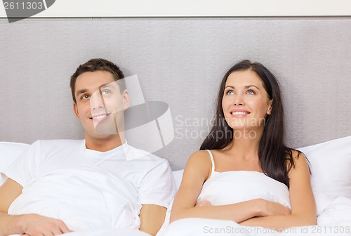 Image of happy couple dreaming in bed