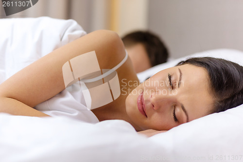 Image of happy couple sleeping in bed