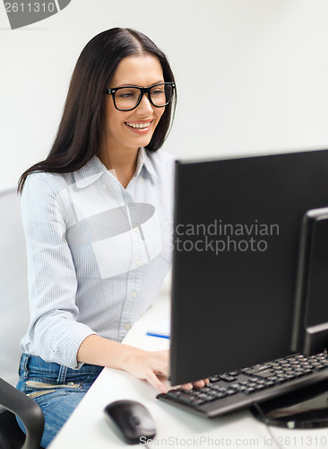 Image of smiling businesswoman or student with eyeglasses