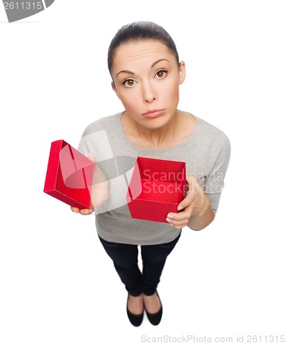 Image of disappointed asian woman with empty red gift box