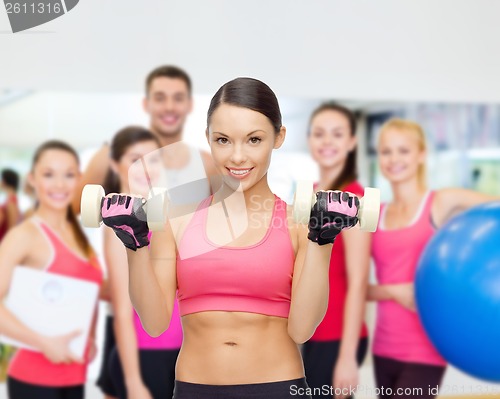 Image of personal trainer with group in gym