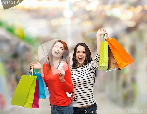 Image of teenage girls with shopping bags and credit card