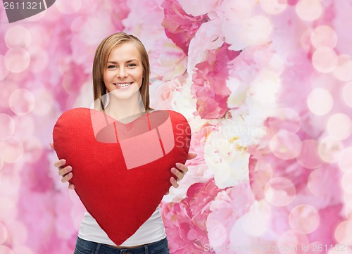 Image of smiling woman in white t-shirt with heart