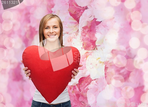 Image of smiling woman in white t-shirt with heart