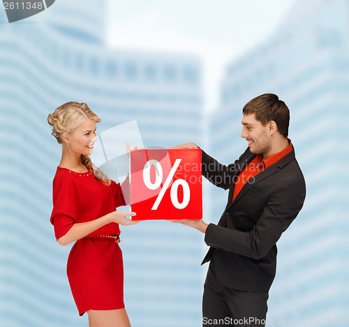 Image of smiling woman and man with red percent sale sign