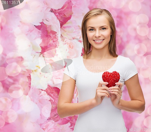 Image of smiling woman in white t-shirt with heart