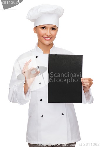 Image of smiling female chef with black blank paper