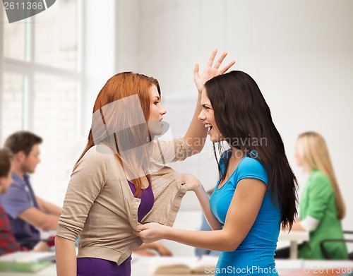 Image of two teenagers having a fight and getting physical