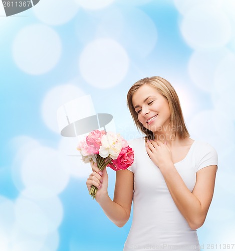 Image of smiling woman with bouquet of flowers