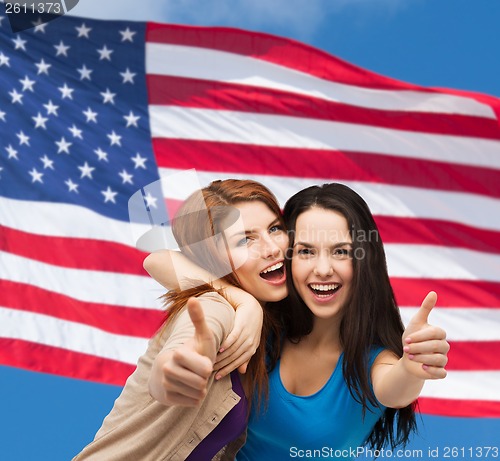 Image of two smiling girls showing thumbs up