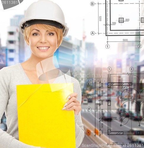 Image of female contractor in helmet with folder