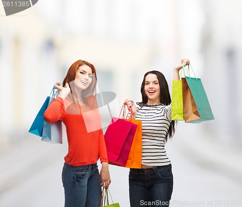 Image of two smiling teenage girls with shopping bags