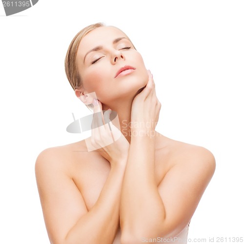 Image of beautiful woman touching her face with closed eyes