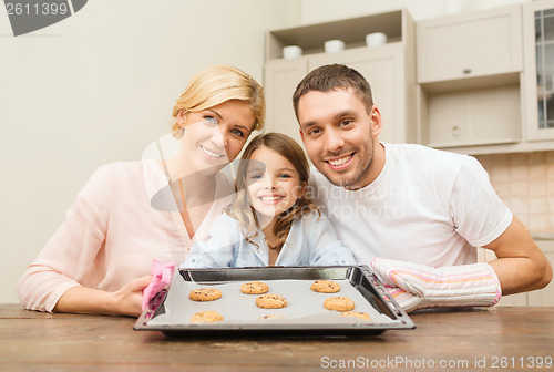 Image of happy family making cookies at home