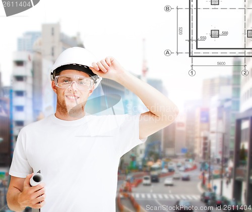 Image of male architect in helmet with blueprint