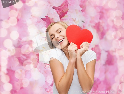 Image of smiling woman in white t-shirt with heart