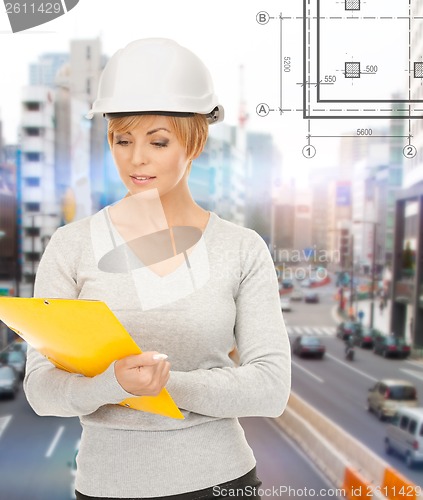 Image of female contractor in helmet with folder